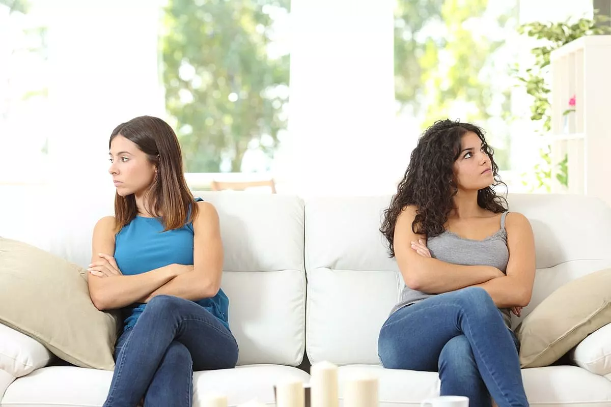 Due donne adirate e girati di spalle su un divano disdegnano lo sguardo fra di loro